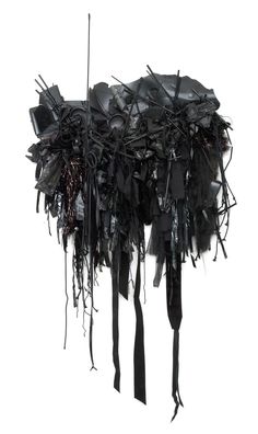 an abstract sculpture made out of black fabric and metal wires on a white background with no one in it