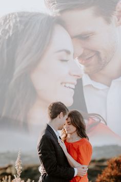 a man and woman standing next to each other in front of a large photo on the wall