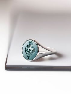 A bloodstone signet ring that can be carved with your own custom design. *real images of the ring, taken by us* Bloodstone Size: 15x13mm Material: - Sterling Silver (925) - 9K Gold (375) - 14K Gold (585) - 18K Gold (750) *All signet rings are hallmarked on the back for certification* - We offer FREE Worldwide DHL & FedEx Shipping! - Branded DanelianJewelry Gift Box with each order! Our customer service is available 7 days a week. Leave us your message, and we will get back to you within a little Luxury Carved Signet Ring, Luxury Carved Round Signet Ring, Hallmarked Oval Rings For Memorial, Heirloom Engraved Oval Enamel Ring, Heirloom Oval Engraved Enamel Ring, Classic Carved Signet Ring For Anniversary, Hallmarked Engraved Memorial Ring, Formal Oval Carved Signet Ring, Classic Oval Engraved Emerald Ring