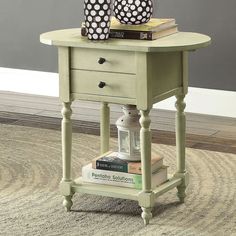 a table with two vases on top of it and some books in front of it