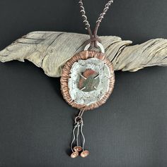 Discover the beauty of nature with this handmade necklace, crafted from textured copper and sterling silver. At its heart lies a unique Lake Superior beach stone set with prongs to showcase its natural beauty. The necklace features an adjustable leather cord, allowing you to wear it at a length that suits your style, from 24 to 30 inches. Adding to its charm are three delicate sterling silver and copper dangles. Perfect for those who appreciate nature-inspired jewelry, this piece brings a touch of rustic elegance to any outfit. Pendant Width 2-3/4" Pendant Height 6" (includes dangles) Rustic Hand Forged Brown Jewelry, Rustic Brown Hand Forged Jewelry, Nature-inspired Hammered Pendant Necklace, Unique Handmade Rust-colored Jewelry, Rustic Bronze Electroformed Necklace, Rustic Brown Hammered Jewelry, Earthy Hand Forged Pendant Necklace, Hand Forged Earthy Pendant Necklace, Unique Handmade Rust-colored Necklace