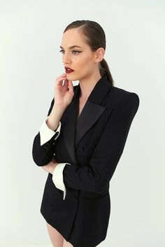 Black tie only. Nevro's flawless vision translates to this black wool tuxero jacket, tailored with hand-rolled shoulders and satin peak lapels. Adding some drama, while the jacket sleeve's length reach up to the wrist, the ending of the sleeves make a hold statement with an extention of white gabardine. Androgynous allure at its best. Elegant Black Double Breasted Suit With Hidden Buttons, Chic Semi-formal Tuxedo With Pressed Crease, Chic Fall Tuxedo For Formal Occasions, Chic Formal Tuxedo For Fall, Tailored Long Sleeve Evening Pantsuit, Tailored Evening Blazer Dress With Structured Boning, Black Double-breasted Formal Blazer, Classic Formal Blazer Dress With Pressed Crease, Classic Blazer Dress For Party With Notch Lapel