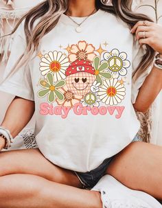 This groovy T-shirt is a must-have for any hippie mama or retro-loving individual. With its colorful retro floral design and peace sign, this shirt exudes good vibes and a laid-back attitude. Perfect for casual wear, this shirt is ideal for lounging around or pairing with jeans for a trendy look. It is relevant for Mother's Day, Earth Day, music festivals, and any hippie-themed events. Product features - Made with 100% Airlume combed and ring-spun cotton - Retail fit perfect for casual and semi-formal settings - Bella+Canvas manufactures in a humane, sustainable way - Tear-away label minimizes skin irritations - Variety of fabric blends for different color options Care instructions - Machine wash: cold (max 30C or 90F) - Non-chlorine: bleach as needed - Tumble dry: low heat - Iron, steam o Hippie Mama, Day Earth, Hippie Shirt, Themed Events, Floral Tee, Music Festivals, Retro Floral, Peace Sign, Earth Day