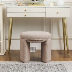 a white dressing table with a mirror and stool