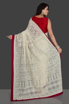 Charming off-white embroidered georgette saree for special occasions. The saree has red raw silk border and comes with a red saree blouse. Buy online embroidered sarees in USA from Pure Elegance. Disclaimer: The actual product may vary slightly from the image. These are custom orders, hence expect slight variation in color, placement of the motif or buta. ESTIMATED DELIVERYBecause this is a custom order, it would take about 4 weeks from the date of purchase. RETURN POLICYThis product is a custom White Embroidered Saree, Red Saree Blouse, Embroidered Sarees, Embroidered Saree, Red Border, Fashion Journals, Red Saree, Traditional Fabric, Georgette Saree