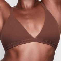 The Ultimate Bra With 2-Ply Supportive Stretch And Second-Skin Softness. Max-Stretch Fabric Never Cuts Into The Skin, Allowing Live-In Comforta Performance Essential With Streamlined Style. Adjustable Shoulder Straps, Triangle Cups, Encased Elastic Underbust Seam The Model Is Size 10 And 5'11", Wearing Skims M 76% Polyamide / 24% Elastane Machine Wash Cold, Non Chlorine Bleach, Cool Iron, Do Not Dry Clean Imported Fitted Low-cut Sports Bra For Loungewear, Low-cut Fitted Sports Bra For Loungewear, Low-cut Sports Bra For Loungewear, Fitted Seamless Brown Sports Bra, Fitted Brown Seamless Sports Bra, Fitted Triangle Top Sports Bra With Seamless Construction, Fitted Bra For Everyday Wear, Fitted Triangle Top Sports Bra With Padded Cups, Fitted Light Support Summer Bra