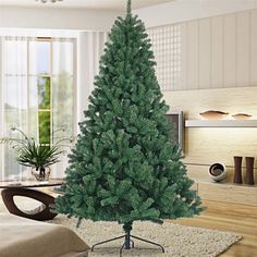 a christmas tree is in the middle of a living room with a rug on the floor