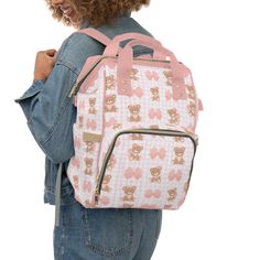 "Introducing our Teddy Bear and pink Coquette ribbon bow print bag!  This versatile multi-purpose diaper bag is designed to simplify your life on the go with a touch of coquette aesthetic. Crafted with care from 100% high-grade nylon, this bag is both durable and stylish, making it a must-have for busy parents. With its spacious yet compact size of 15.0\" × 10.8\" × 6.7'', it strikes the perfect balance between functionality and convenience. Comfort is key, which is why we've equipped this bag with adjustable shoulder straps and a padded back panel. Say goodbye to discomfort and hello to effortless carrying, whether you're strolling through the park or rushing through the airport. The bag's thoughtfully designed interior features one main pocket with a reliable zipper closure, ensuring the Cute Pink Diaper Bag For Daily Use, Cute Rectangular Travel Diaper Bag, Cute Large Capacity Pink Backpack, Cute Diaper Bag Backpack For Daily Use, Cute Backpack Diaper Bag For Daily Use, Cute Daily Use Diaper Bag Backpack, Cute Pink Diaper Bag For Everyday, Pink Rectangular Diaper Bag For Travel, Pink Rectangular Diaper Bag For Daily Use