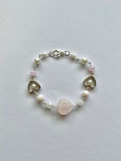 super cute pink rose quartz heart beaded bracelet! a perfect gift for a crystal lover!  made with rose quartz bead, glass beads, small acrylic beads, and stainless steel findings! Valentine's Day Silver Beaded Crystal Bracelet, Silver Beaded Crystal Bracelet For Valentine's Day, Silver Beaded Rose Quartz Bracelets, Pink Beaded Crystal Bracelet For Valentine's Day, Dainty Pink Rose Quartz Beaded Bracelets, Dainty Pink Rose Quartz Beaded Bracelet, Rose Quartz Beaded Bracelets For Valentine's Day, Rose Quartz Round Beads Bracelet For Valentine's Day, Pink Rose Quartz Bracelets For Valentine's Day