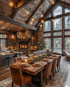 a dining room table with place settings in front of a fireplace and large windows that look out onto the forest