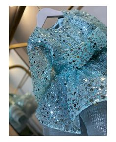 a blue dress with sequins on it