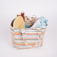 a striped tote bag filled with personal items