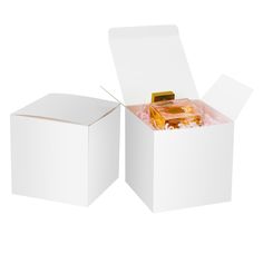 an open white box with some food inside