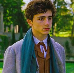 a young man wearing a suit and tie