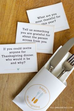 three cards with forks and knives on top of a wooden table next to each other