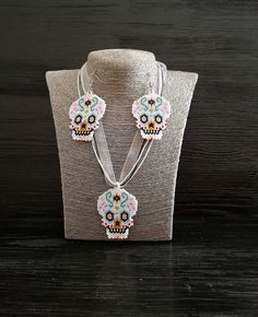 Let me me present you festival style gothic beadwork jewelry set. This sugar skull seed bead earrings and pendant necklace would be great happy Halloween gift set jewelry. The length of the cord is 18.1 (+2) inches. The cord consists of 2 waxed cords of black color, one cord white color and a white ribbon. Pendant high is 2.2 inches, pendant width is 1.8 inches. The length of earrings is 3 inches, the width is 1.8 inches, the length without closure (drop length) is 2.2 inches. You can buy earrings from this set separately by this link https://www.etsy.com/listing/720553398/sugar-skull-helloween-earrings-fesival?ref=shop_home_active_8&frs=1 You can buy pendant necklace from this set separately by this link https://www.etsy.com/listing/721523768/human-sugar-skull-beadwork-art-pendant?ref=sho Day Of The Dead Beaded Jewelry Gift, Handmade Bohemian Jewelry For Halloween, Handmade Beaded Necklaces For Halloween Gift, Festival Skull-shaped Beaded Jewelry, White Skull Jewelry For Day Of The Dead, Handmade Black Jewelry For Day Of The Dead, Beaded Jewelry For Halloween Festival, Black Jewelry For Day Of The Dead Gift, Day Of The Dead Skull Jewelry Gift