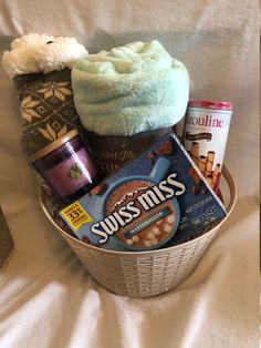 a basket filled with items sitting on top of a bed