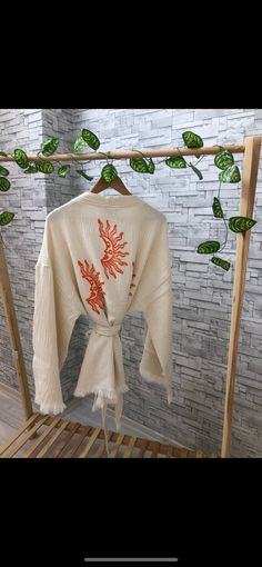 Beautiful handmade white short tassel kimono cardigan jacket with orange sun moon. ethnic boho kimono robe, designed with cotton fabric, flows as you move for comfortable wear. This is a lovely, good-quality kimono, with traditional breathable kimono sleeves. The belt ties around the waist. Great to wear around the house, on beaches, or to dress up with some jeans & a T-shirt, covering up on the beach with a swimsuit. The bird print is really elegant and beautiful. We love kimonos as they are so White Hippie Kimono For Spring, Long Bohemian Orange Kimono, White Bohemian Kimono For Festival, Bohemian Orange Wrap Kimono, Orange Long Sleeve Kimono For Festivals, Traditional Orange Kimono For Summer, Long-sleeved Tassel Kimono For Festivals, Long Sleeve Kimono With Tassels For Festival, Long Sleeve Tassel Kimono For Festivals