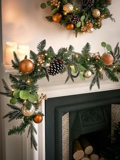 a fireplace decorated for christmas with pine cones and ornaments