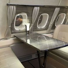 the inside of an airplane with tables and chairs