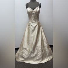 a white wedding dress on display in front of a mannequin's head