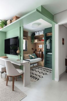 a living room with green walls and white carpeted flooring in the middle of it