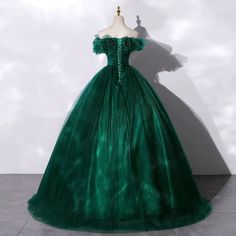 Embrace a vision of enchantment with our Gothic Emerald Green Tulle Wedding Dress, featuring a stunning Layered Ruffle Neckline. This dress epitomizes bridal beauty with its opulent tulle construction that creates a dramatic, full-bodied silhouette. The lush layers of ruffles at the neckline provide a soft, romantic fr Green Ball Gown Quinceanera Dress For Wedding, Organza Quinceanera Dress With Ruffles For Wedding, Wedding Quinceanera Dress With Ruffles In Organza, Elegant Tulle Quinceanera Dress With Ruffles, Elegant Quinceanera Dress With Ruffles In Tulle, Elegant Quinceanera Dress With Ruffles For Wedding, Elegant Green Floor-length Quinceanera Dress, Elegant Quinceanera Dress With Ruffles For Prom, Green Wedding Dress With Sweep Train For Debutante Ball