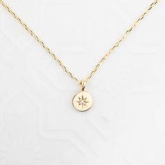 "This necklace symbolizes Sirius, the brightest diamond in the night sky and it is a perfect choice for layering with our star constellation necklace. This handcrafted necklace is lightweight yet very sturdy. The chain is faceted and shimmers as you wear it. Disc size: approx. 5.8mmx5.8mm White diamond, approx. 0.006ct G color SI clarity Solid 14k gold diamond cut chain, adjustable lengths at 16\" and 18\" with spring ring clasp Made of 100% solid gold and ethically sourced gemstone" Delicate Star-shaped Yellow Gold Necklace, Delicate Yellow Gold Star Necklace, Delicate 14k Gold Star Necklace, Celestial Style 14k White Gold Necklace, Minimalist Yellow Gold Jewelry With Star Charm, Delicate Yellow Gold Star Jewelry, Celestial 14k Gold Diamond Necklace Gift, Star Of David Necklace With Single Cut Diamonds, 14k Gold Celestial Necklace With Diamond Accents