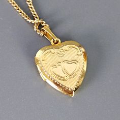 Vintage Gold Toned Gilt Heart Locket Necklace 1970's  necklace length 17.5" Pre- owned good condition Vintage Charm Heart Pendant Necklace For Anniversary, Heart Charm Medallion Necklace For Anniversary, Anniversary Necklace With Vintage Charm And Heart Pendant, Valentine's Day Medallion Necklace With Vintage Charm, Valentine's Day Vintage Charm Medallion Necklace, Vintage Heart Pendant Locket Necklace With Adjustable Chain, Retro Heart-shaped Necklace For Gift, Retro Heart-shaped Necklace Gift, Yellow Gold Heart Necklace With Vintage Charm