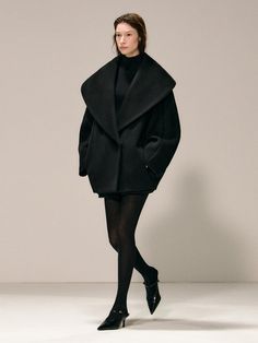 This luxurious 100% wool coat features a sophisticated shawl collar and cocoon silhouette that strikes the perfect balance between bold and elegant styling. The thoughtfully designed piece includes practical details like concealed zipper pockets and a hidden double snap closure, while the wide lapel and dolman sleeves create a refined structural element. Available in both black and khaki, this fully-lined coat offers a generous fit with clean lines that make it a versatile addition to any cold-w Wool Coat Black, Elegant Styling, Black And Khaki, Coat Black, Shawl Collar, Dolman Sleeve, Black Coat, Wool Coat, Clean Lines