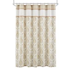 a shower curtain with a beige and white paisley pattern on it, hanging from a metal rod