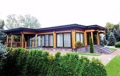 the house is made out of wood and has two large windows on each side of it