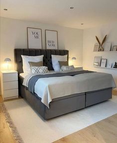 a large bed sitting in the middle of a bedroom next to two lamps on either side of it