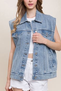 DetailsA denim vest featuring a boxy fit, collar, and functional pockets 100% cotton Casual Sleeveless Denim Vest With Pockets, Fall Sleeveless Denim Vest With Pockets, Casual Washed Blue Denim Vest With Pockets, Casual Cotton Denim Vest With Pockets, Spring Cotton Denim Vest With Pockets, Casual Denim Blue Sleeveless Vest, Casual Sleeveless Denim Blue Vest, Casual Sleeveless Denim Vest, Sleeveless Denim Top With Pockets