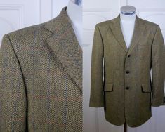 This 80s blazer has a a subtle windowpane check pattern in blue and rust over a golden brown herringbone tweed wool fabric. The handsome European vintage blazer has a notch collar and padded shoulders, and closes in the front with three leather buttons. Four buttons decorate each sleeve cuff. The jacket has three pockets on the front, is fully lined in a satin viscose fabric, and a center vent in back ensures complete ease of movement. Size: 42 US/UK (made in Portugal) Material: Wool Condition: 80s Blazer, Mens Blazers, Mens Sport Coat, Herringbone Tweed, Vintage Blazer, Single Breasted Jacket, European Vintage, Tweed Blazer, Corduroy Jacket