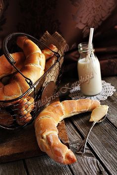 bread in a basket next to a bottle of milk