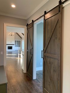 an open door leading to a kitchen and living room in a house with hardwood floors