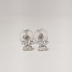 "Thanks for shopping our vintage estate store. We tend to sell well below wholesale and truly hope you enjoy all of our items. Many of the items are one of a kind, so please enjoy scrolling through the pictures and hopefully something will catch your eye. Brown spots are from camera or reflections. Nice estate 18k white gold .10ct diamond stud pedal flower earrings.  There are 8 diamonds for each the set, beautiful setting, some that you will love.  Setting: 3.5mm 1/4\" Weight: 0.49 gram Carat: .025ct per stud Clarity: SI2 Color: G Marked 18k and backs are included." Classic Hallmarked Diamond Earrings, Formal White Gold Cluster Earrings Hallmarked, Hallmarked White Gold Diamond Earrings, White Gold Hallmarked Diamond Earrings, Brilliant Cut Marquise Diamond Earrings For Anniversary, Anniversary Diamond Earrings Marquise Brilliant Cut, Classic Marquise Cluster Diamond Earrings, Classic Marquise Diamond Cluster Earrings, Classic White Gold Marquise Earrings