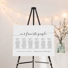 an easel with a sign that says our favorite people on it and lights in the background