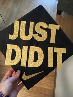 a black and gold graduation cap that says just did it