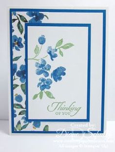 a card with blue flowers on it and the words thinking of you written in green