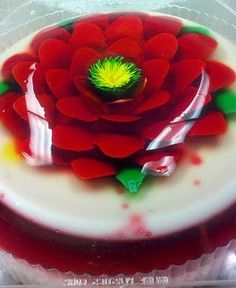 a red and white cake with a flower on top