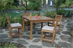 a wooden table with four chairs around it