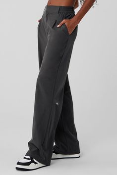 These trousers have “closet staple” written all over them. They have a high-rise waistband (flat in the front and stretchy in the back), classic details (belt loops and pleats) and a relaxed, wide-leg fit. Plus, they’re made from a lightweight, slightly stretchy fabric that looks sleek and feels totally comfortable. You'll go straight from work to your weekend plans with just a change of shoes. Grey Target Pants, Casual Training Pants, Women’s Basics Pants, Black Straight Pants Women, Wide Leg Pants Adidas, Casual Track Pants, Black Studio Pants, Black Alo Pants, Athletic Fit Pants