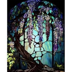 a stained glass window with purple and green flowers hanging from it's sides, in front of a tree