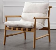 a wooden chair with a white pillow on it's back and seat padding