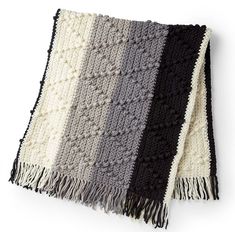 a black, white and grey blanket with fringes