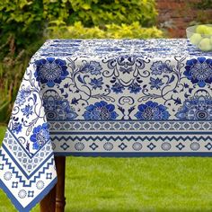 a blue and white table cloth with fruit on it