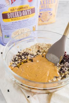 a bowl filled with oats, raisins and peanut butter