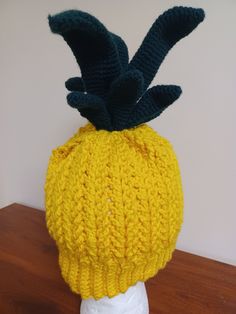 This pineapple hat is made with yellow acrylic yarn and topped with dark green stems that stand up when wearing.  Size is customized to your liking. Pineapple Hat, Hat Custom, Acrylic Yarn, Stand Up, Dark Green, Caps Hats, Pineapple, Accessories Hats, Winter Hats